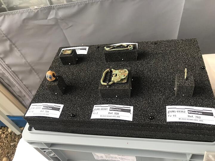 Etliche spannende Funde haben die Archäologen im Boden gefunden. Die keltische Sicherheitsnadel aus Bronze (oben Mitte) sieht fast aus, wie heute auch. Darunter zu sehen: eine römische Mini-Schnalle, die am Gewand getragen wurde. Links unten eine Glaspere.