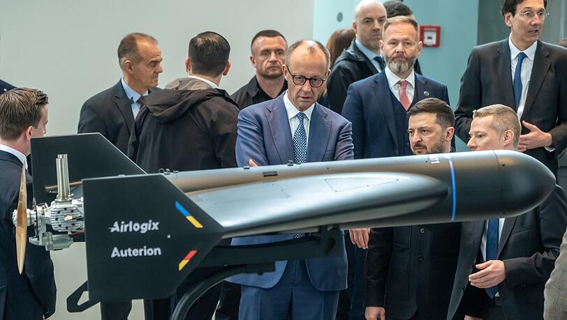 Diese Drohne von Auterion und Airlogix hat eine Reichweite von bis zu 1500 Kilometern. Im April führte sie Auterion-Chef Lorenz Meier (ganz inks, seitlich von hinten zu sehen) Bundeskanzler Friedrich Merz (CDU) und dem ukrainischen Präsident Wolodymyr Selenskyj vor. Diese Drohne von Auterion und Airlogix hat eine Reichweite von bis zu 1500 Kilometern. Im April führte sie Auterion-Chef Lorenz Meier (ganz inks, seitlich von hinten zu sehen) Bundeskanzler Friedrich Merz (CDU) und dem ukrainischen Präsident Wolodymyr Selenskyj vor.
