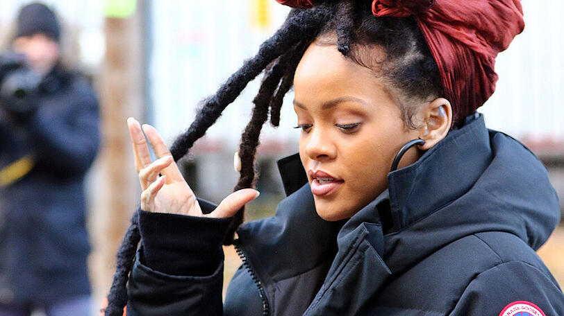 Sängerin Rihanna im Wintermantel.