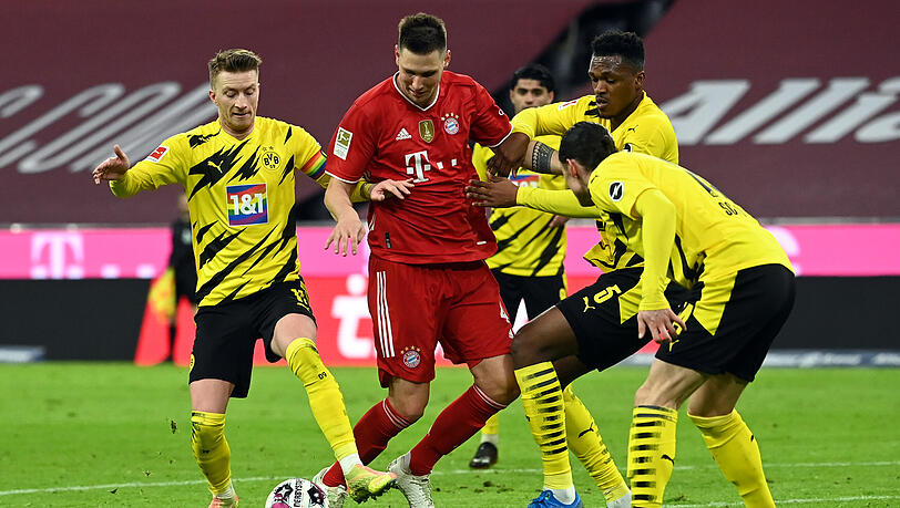 Dortmund oder Bayern? Wer holt die Meisterschale? (vl.) Dortmunds Mittelfeldspieler Marco Reus und die Abwehrspieler Dan-Axel Zagadou und Nico Schulz gegen Niklas Süle vom FC Bayern.