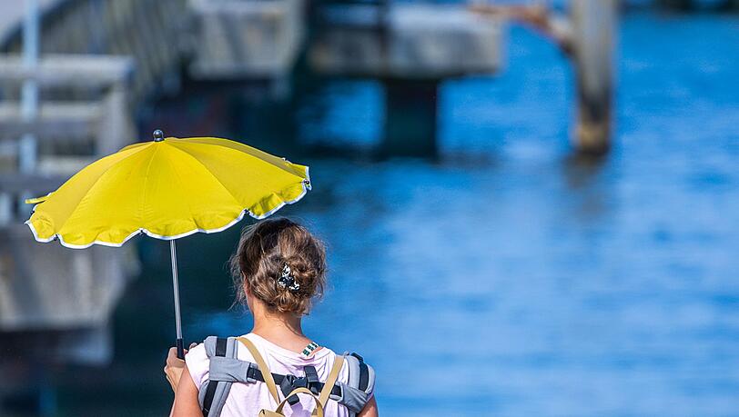 Manche helfen sich mit Sonnenschirmen.