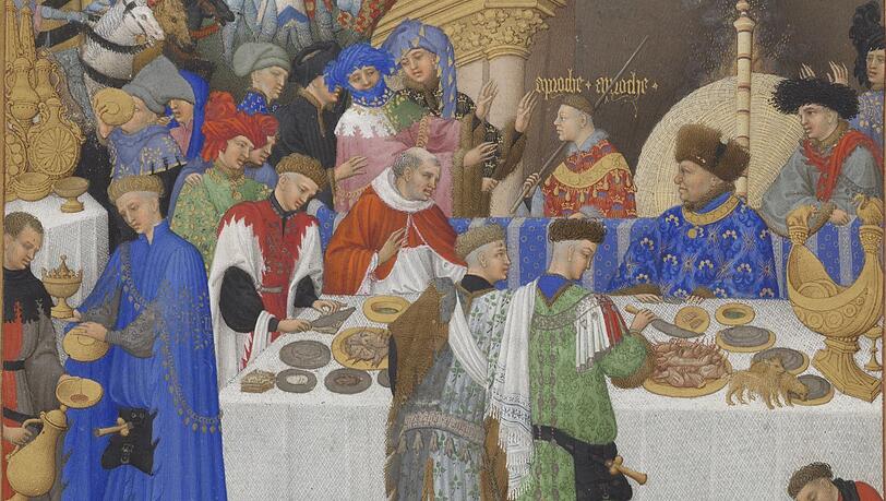 Mit diesem fulminanten Neujahrsempfang beginnen die Monatsdarstellungen in den „Très Riches Heures“, dem berühmtesten Stundenbuch des Mittelalters. Der Herzog von Berry - rechts am Tisch mit Bärenfellhut - begrüßt seine Gäste und ist dabei der einzige, der etwas zu essen bekommt. Bis auf die kleinen Hunde auf dem Tisch.