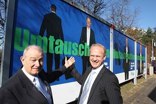 Umtauschaktion: OB Maly nimmt den Koffer und Klemens Gsell kommt. Günther Beckstein und OB-Kandidat Gsell (rechts) präsentieren das Endspurt-Plakat der Nürnberger CSU.