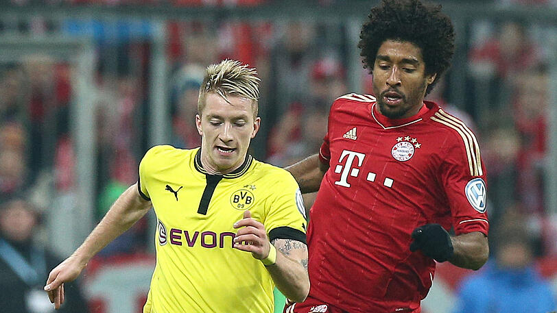 Im vorgezogenen Endspiel gewinnen die Bayern - und dürfen endlich auch wieder in einem bedeutenden Wettbewerb jubeln. Hier kämpfen der Dortmunder Marco Reus (links) und Bayern-Profi Dante um den Ball.
