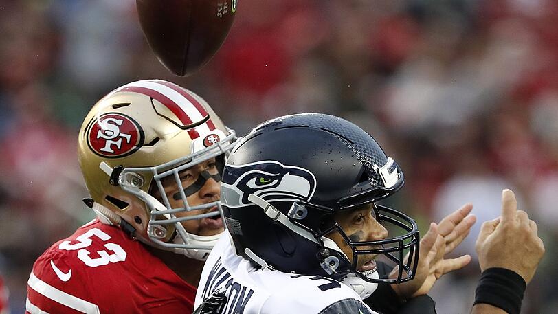 Mark Nzeocha von den San Francisco 49ers (links) in Duell mit Seattle-Seahawks-Quarterback Russell Wilson.