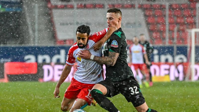Marco Friedl von Werder (r) und Sarpreet Singh von Regensburg kämpfen um den Ball.