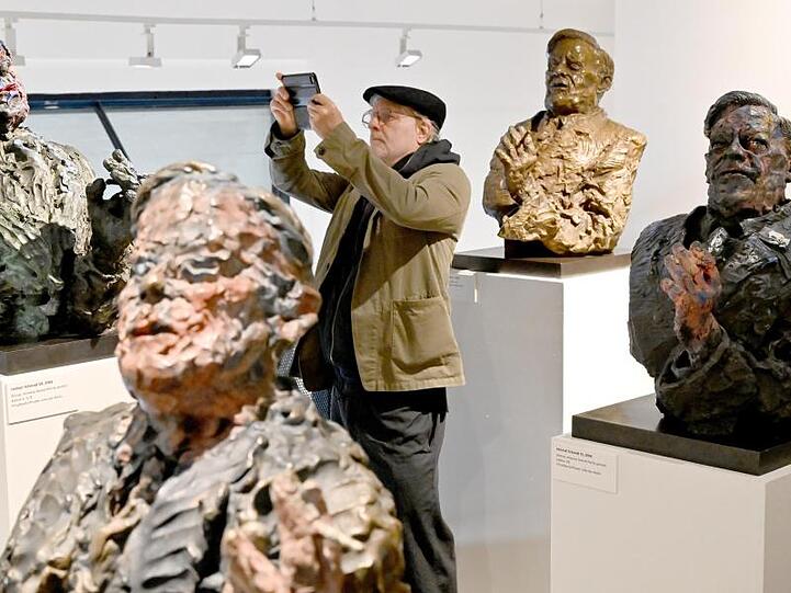 Der Künstler Rainer Fetting zwischen Helmut-Schmidt-Skulpturen.