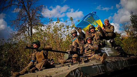 Ukrainische Soldaten fahren eine Straße zwischen Isjum und Lyman entlang.