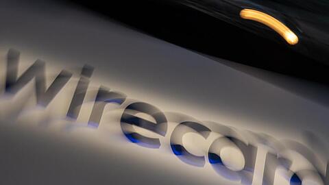 Ein Schild mit der Aufschrift "wirecard". Foto: Peter Kneffel/dpa