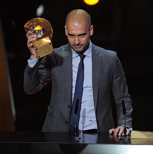 Als Trainer gibt es in der Titelsammlung Guardiolas praktisch nichts, was es nicht gibt. Guardiola ist auch ein Mann mit Prinzipien. So weigerte er sich 2010 beharrlich, einen länger als ein Jahr gültigen Vertrag zu unterzeichnen. Andere Menschen wären vielleicht ganz gerne Trainer des FC Barcelona. Er sagt dazu: &bdquo;Trainer von Barça kann man nicht auf Lebenszeit sein. Ich denke, dass man für kurze Zeiträume unterschreiben sollte, in denen der Trainer sich Dinge verdienen muss, [die Unterstützung] der Spieler, der Fans&ldquo;. Hier nimmt er die Ehrung als Welttrainer 2011 entgegen.