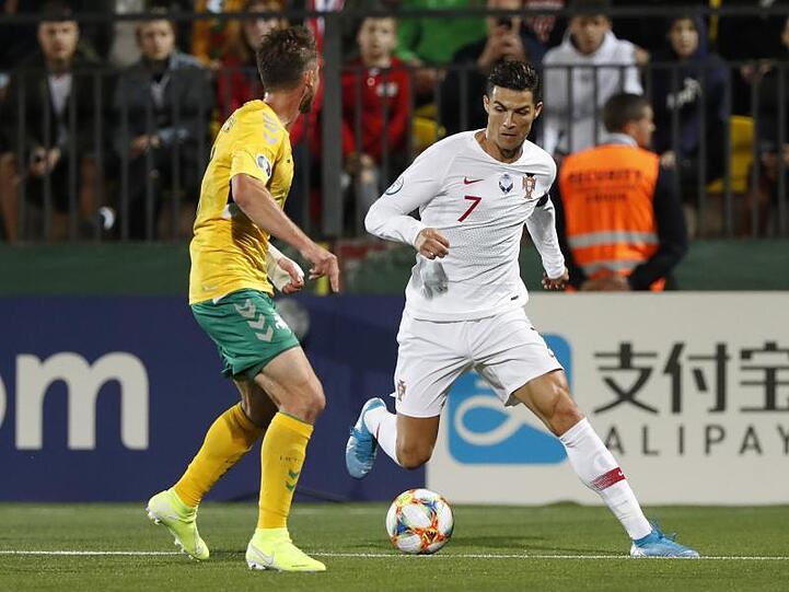 Cristiano Ronaldo (r) im Duell mit dem Litauer Saulius Mikoliunas.