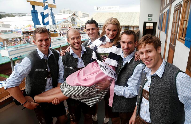 Starke Typen, schöne Frau - die EHC-Spieler mit Wiesn-Playmate Kathrin Göppert in der Bräurosl.