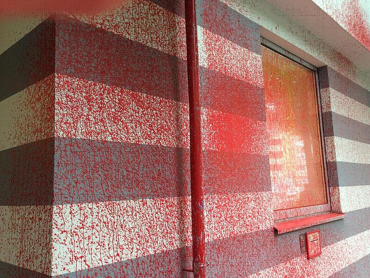 Auch das Fenster rechts vom Eingang hat viel Farbe abbekommen.
