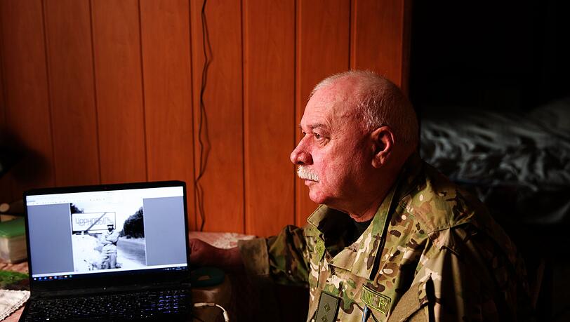 Andriy Kulish mit einem Foto, das ihn zu Beginn des Einsatzes am Ortsausgang von Tschernobyl zeigt.