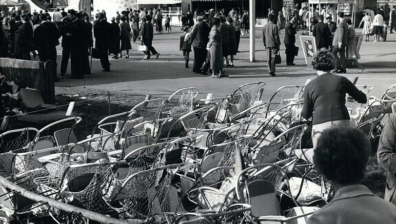Eigentlich ganz praktisch: Den Kinderwagen können Eltern 1961 einfach vor der Wiesn parken und dann mit dem Kind auf dem Arm oder an der Hand über das (zumindest zum Zeitpunkt dieser Aufnahme) nicht sehr volle Festgelände spazieren. Eigentlich ganz praktisch: Den Kinderwagen können Eltern 1961 einfach vor der Wiesn parken und dann mit dem Kind auf dem Arm oder an der Hand über das (zumindest zum Zeitpunkt dieser Aufnahme) nicht sehr volle Festgelände spazieren.