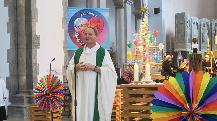 Kreativer Stadtpfarrer: Rainer Maria Schießler, hier in seiner bunt geschmückten Kirche St. Maximilian bei der Faschings-Messe.