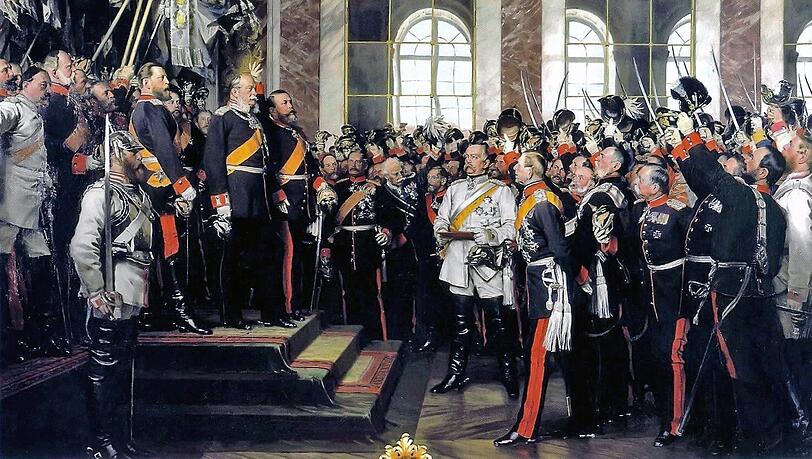 Der preußische Kronprinz Friedrich Wilhelm (rechts hinter dem Kürassier) ließ im Januar 1871 den Maler Anton von Werner von Karlsruhe ins Große Hauptquartier nach Versailles bitten, damit er etwas seines "Pinsels Würdiges" erlebe. Dass es sich dabei um die Proklamation des Deutschen Kaiserreiches handeln würde, erfuhr Werner erst unmittelbar zuvor. Sein Gemälde zeigt den Moment, in dem der Großherzog von Baden den neuen Kaiser hochleben lässt. Vorn, in weißer Uniform, Reichskanzler Otto von Bismarck. Der preußische Kronprinz Friedrich Wilhelm (rechts hinter dem Kürassier) ließ im Januar 1871 den Maler Anton von Werner von Karlsruhe ins Große Hauptquartier nach Versailles bitten, damit er etwas seines "Pinsels Würdiges" erlebe. Dass es sich dabei um die Proklamation des Deutschen Kaiserreiches handeln würde, erfuhr Werner erst unmittelbar zuvor. Sein Gemälde zeigt den Moment, in dem der Großherzog von Baden den neuen Kaiser hochleben lässt. Vorn, in weißer Uniform, Reichskanzler Otto von Bismarck.