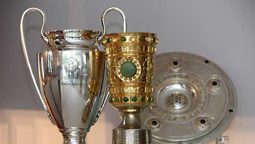 Um diese Trophäen geht es: Pokale der Champions-League und des DFB-Cups sowie die Meisterschale Um diese Trophäen geht es: Pokale der Champions-League und des DFB-Cups sowie die Meisterschale