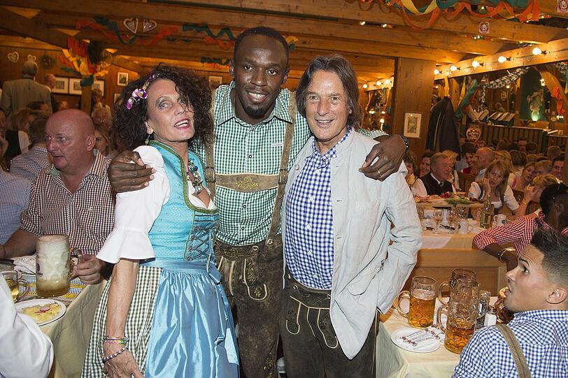 Karin Müller-Wohlfahrt mit Usain Bolt und Ehemann Hans-Wilhelm Müller-Wohlfahrt im Schützenzelt.