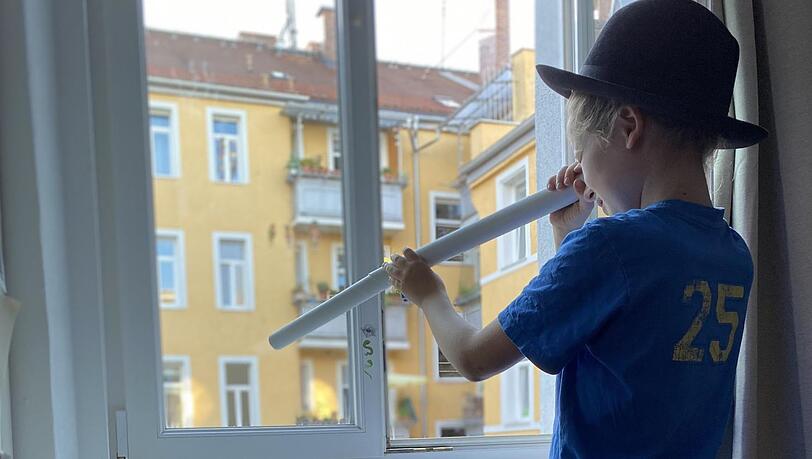 Paul hat einen negativen Coronatest - er darf trotzdem nicht draußen spielen. Da bleibt nur ein sehnsüchtiger Blick aus dem Fenster.