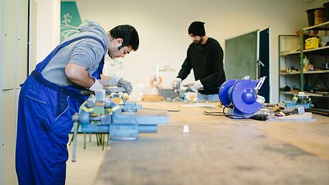 Der afghanische Flüchtling Sha Kah Ahmadi (l) und der indische Flüchtling Singh Satwinder feilen in der Fortbildungsakademie der Wirtschaft in Dresden an Metallwerkstücken. Handwerksbetriebe und die Bundesagentur für Arbeit haben mehr als 6000 Plätze für Flüchtlinge bereitgestellt. Foto: Oliver Killig/Archiv