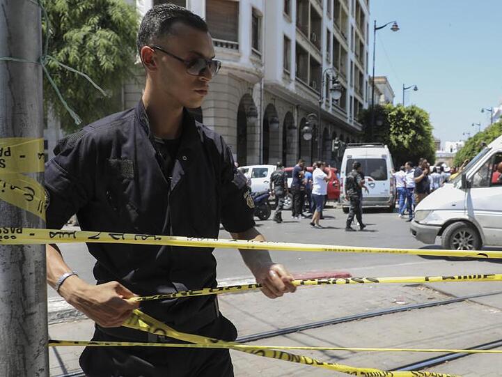 Ein Polizist sperrt den Tatort in Tunis ab.
