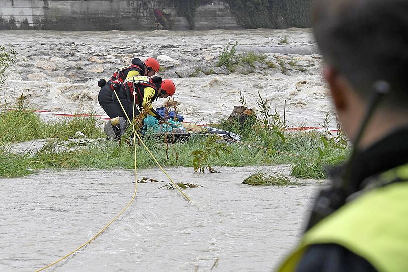 Einsatzkräfte der Wasserrettung bergen Habseligkeiten aus dem Obdachlosenlager unter der Reichenbachbrücke.