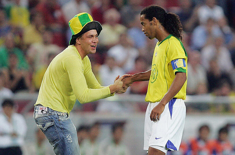 Kurios auch der Auftritt beim Confederations Cup, als ein Brasilien Fan Ronaldinho unbedingt die Hand schütteln will. Vor kurzem ging der ehemalige Superstar auch recht locker mit einem Flitzer um, setzte seine Unterschrift auf dessen Trikot.