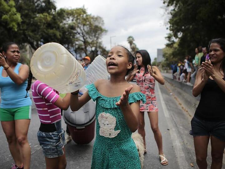 Frauen protestieren mit leeren Kanistern gegen den Wassermangel in Caracas.