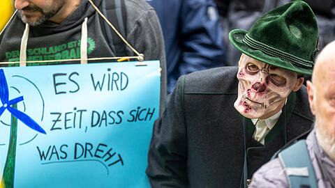 Ein Mann mit Totenschädel-Maske nimmt an einer Kundgebung vom Bündnis für Atomausstieg am Odeonsplatz teil.