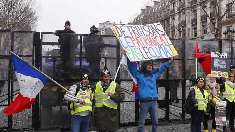 Demonstranten der "Gelbwesten"-Bewegung vor einer Straßensperre der Polizei in Paris. Francois Mori/AP Demonstranten der "Gelbwesten"-Bewegung vor einer Straßensperre der Polizei in Paris. Francois Mori/AP