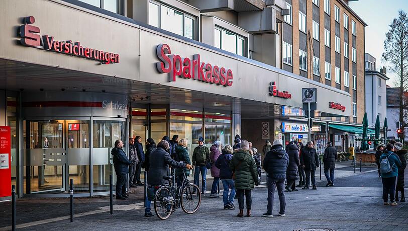 Nach einem Einbruch in den Tresorraum einer Bankfiliale in Gelsenkirchen warten Menschen vor dem Eingang auf Informationen. Nach einem Einbruch in den Tresorraum einer Bankfiliale in Gelsenkirchen warten Menschen vor dem Eingang auf Informationen.