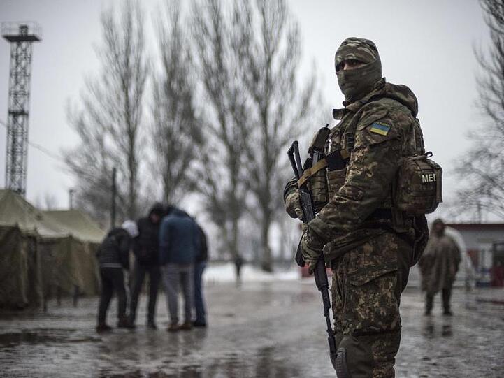 Ein ukrainischer Soldat patrouilliert an einem Stützpunkt für humanitäre Hilfe in der Ostukraine. Für das seit 2014 umkämpfte Gebiet gibt es neue Hoffnungen auf Friedensgespräche.