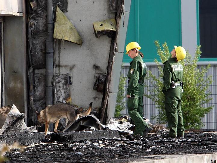 Spürhunde der Polizei vor einer abgebrannten Turnhalle in Potsdam. Ein Feuer hatte die geplante Flüchtlingsunterkunft zerstört.