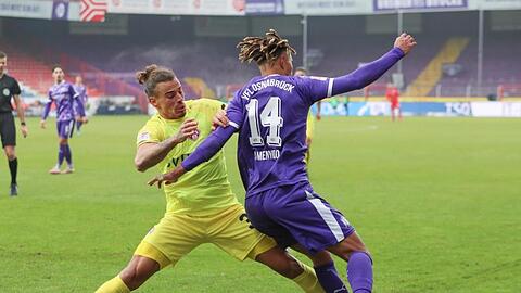 Rolf Feltscher aus Würzburg und Osnabrücks Etienne Amenyido (l-r.) im Kampf um den Ball.