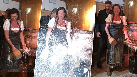 Ilse Aigner kassiert beim Anzapfen eine gehörige Bierdusche.