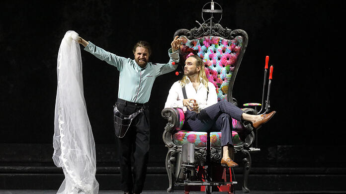 Konstantin Krimmel (Figaro, l.) und Huw Montague Rendall (Graf) und der ominöse Luststuhl in Evegny Titovs Mozart-Inszenierung im Nationaltheater.
