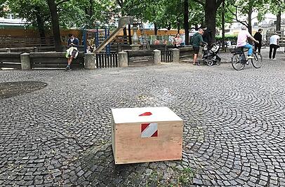 Seit dem Rangierunfall verdeckt diese Holzkiste den Stumpf der Burgfriedensäule, der noch zwei Handbreit aus dem Kopfsteinpflaster ragt.  iko