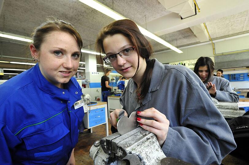 Girls&lsquo; Day bei den SWM: Sabrina Sponfeldner feilt an einem Metall-Herzen. Dabei wird sie von SWM Mitarbeiterin Felicitas Okelmann (links) unterstützt.