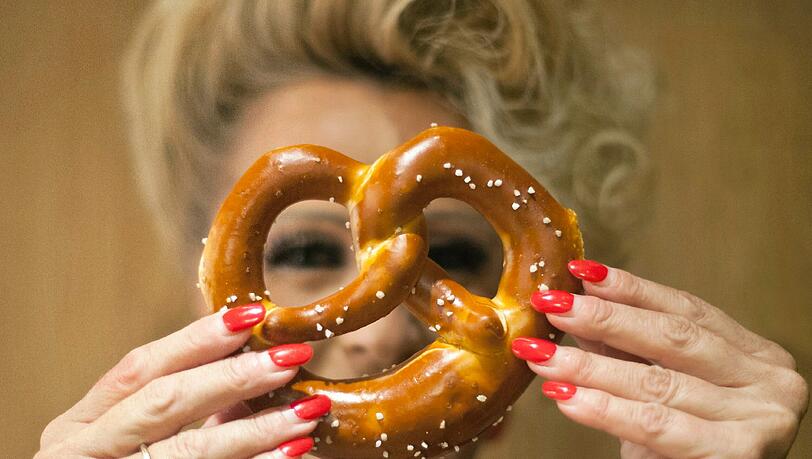 Die Besitzerin der Bäckerei Hoffmann, Anett Hoffmann, hält sich am 12.09.2012 in München (Oberbayern) eine Brezel vor ihr Gesicht. Der Markt für kleine Bäckereien wir immer härter. Bäckermeister müssen kreativ sein, um sich gegenüber Backshops und Discountern zu beweisen. Die Besitzerin der Bäckerei Hoffmann, Anett Hoffmann, hält sich am 12.09.2012 in München (Oberbayern) eine Brezel vor ihr Gesicht. Der Markt für kleine Bäckereien wir immer härter. Bäckermeister müssen kreativ sein, um sich gegenüber Backshops und Discountern zu beweisen.
