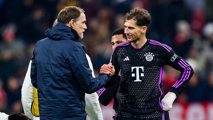 Münchens Trainer Thomas Tuchel (l) klatscht nach dem Spiel mit Münchens Leon Goretzka (r) ab.