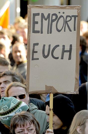 Demonstranten stehen mit Plakaten am Stachus in München (Vorbild der Demonstrationen ist die amerikanische Protestbewegung «Occupy Wall Street» («Besetzt die Wall Street»), die sich gegen das Finanzsystem und große Teile der Bankenwelt wendet.