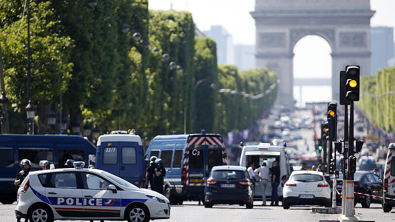 Polizisten blockieren die Zufahrt zu den Champs Elysees in Paris. Ein Mann war mit seinem Auto auf ein Fahrzeug der Gendarmerie geprallt.
