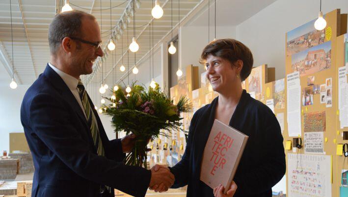 Andres Lepik begrüßte die 50.000ste Besucherin der Ausstellung "Afritecture – Bauen mit der Gemeinschaft", Fiona Hemmi. Andres Lepik begrüßte die 50.000ste Besucherin der Ausstellung "Afritecture – Bauen mit der Gemeinschaft", Fiona Hemmi.