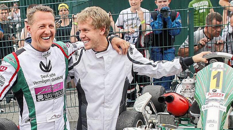 Sebastian Vettel (r.) und sein Vorbild Michael Schumacher.