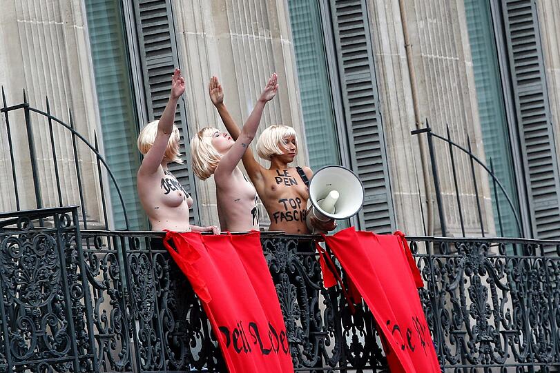 Bei einer Maikundgebung auf dem Pariser Opernplatz zeigten drei Femen-Aktivistinnen der Chefin der rechtsextremen französischen Partei Front National den Hitlergruß. Die Bilder.