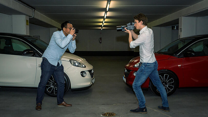 People- und Lifestyle-Fotograf Minh-Tuan Truong (links) und Philip Reichwein, der High-Fashion- und Beauty-Fotograf &ndash; beide vor zwei Modellen des Opel Adam aus der "GNTM"-Edition, zur Verfügung gestellt von Schöne Münchnerin-Partner Häusler.