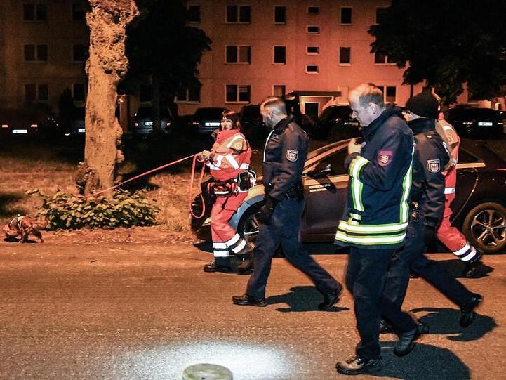 Polizisten und ein Feuerwehrmann begleiteten Mitarbeiterinnen der Rettungshundestaffel bei der Suche nach der vermissten 6-Jährigen in Potsdam.