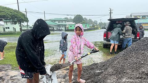 In Hawaii f&uuml;llen Menschen Sands&auml;cke, um ihre H&auml;user vor den Auswirkungen von "Nolo" zu sch&uuml;tzen.