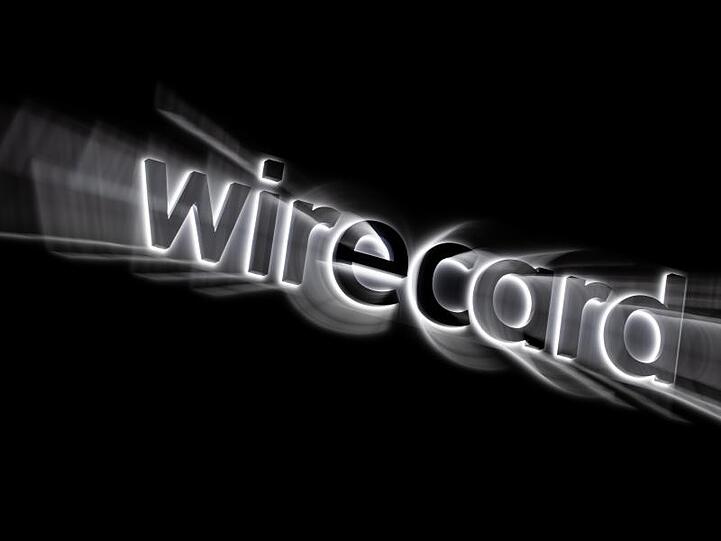 Das Logo von Wirecard hängt an der Fassade des Firmensitzes in Aschheim bei München. Foto: Peter Kneffel/dpa/Symbolbild
